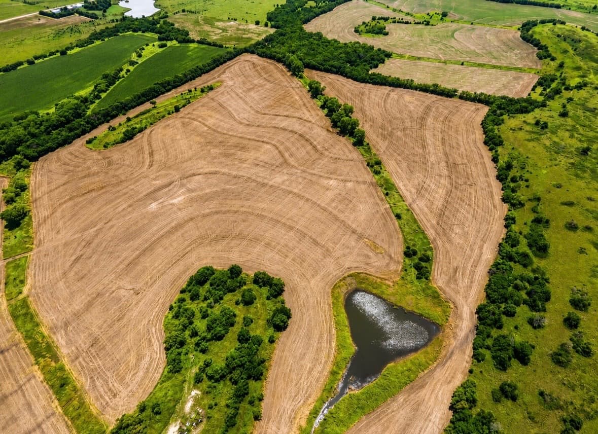 Aerial view of Prairie Haven — timber, crop fields and ponds